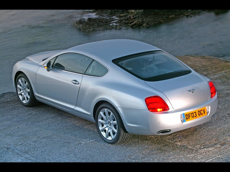 silver bentley coupe by water
