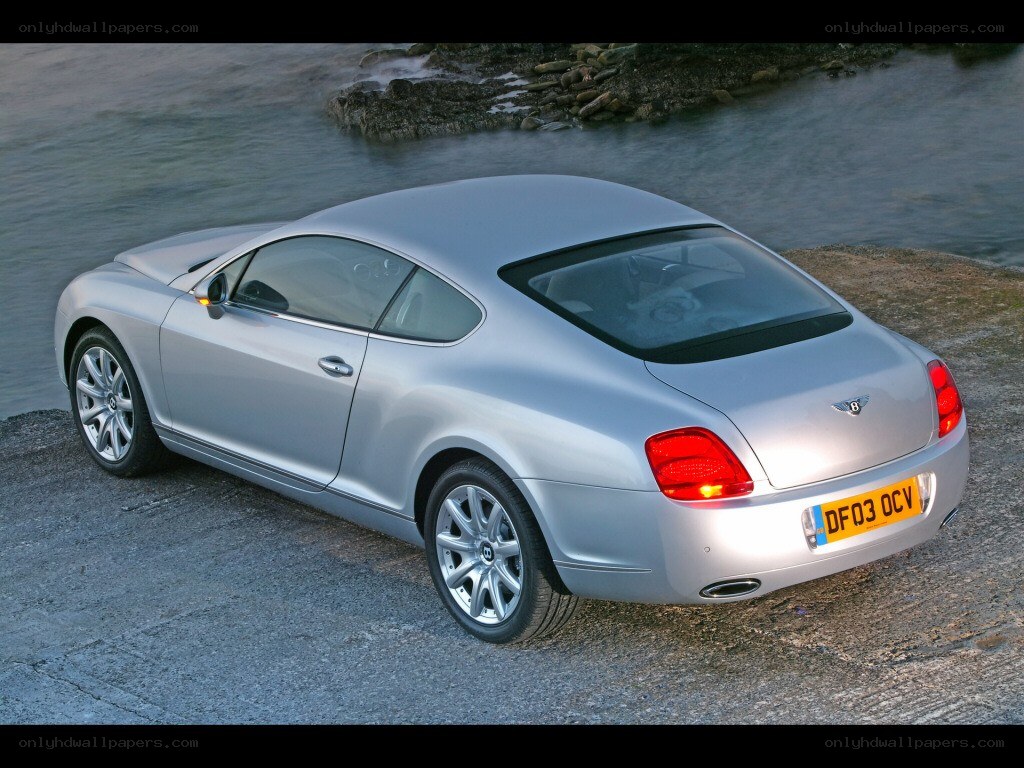 silver bentley coupe by water