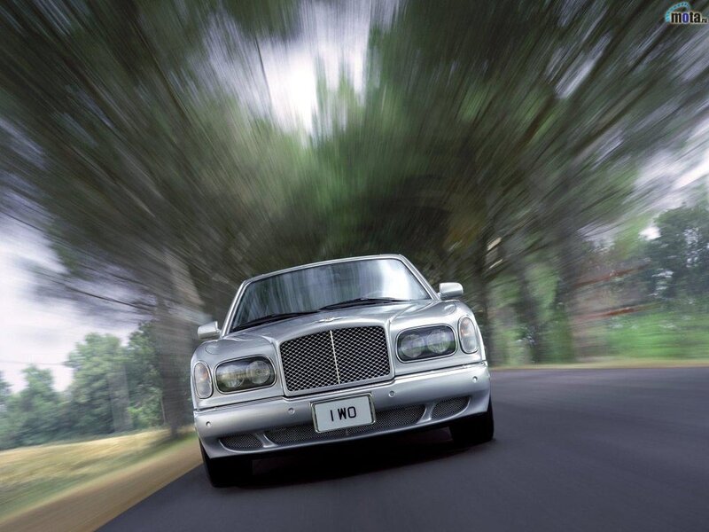 silver bentley driving fast