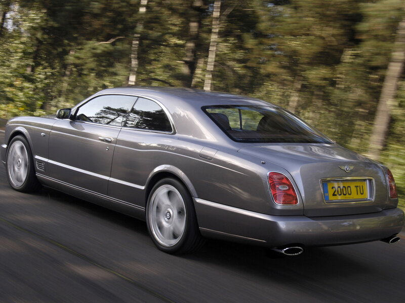 silver bentley driving on road