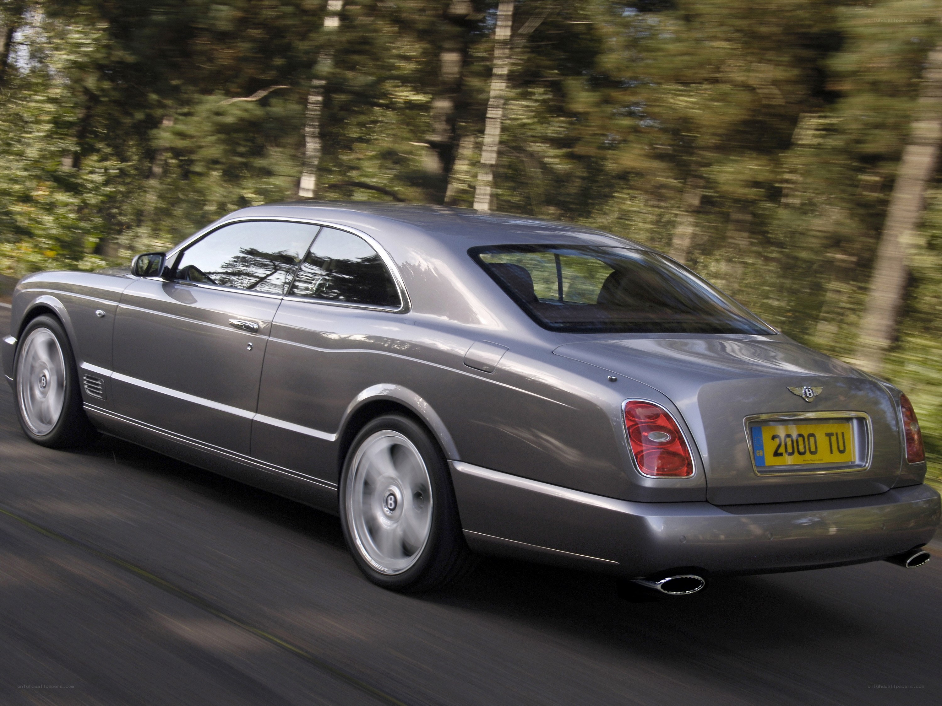 silver bentley driving on road