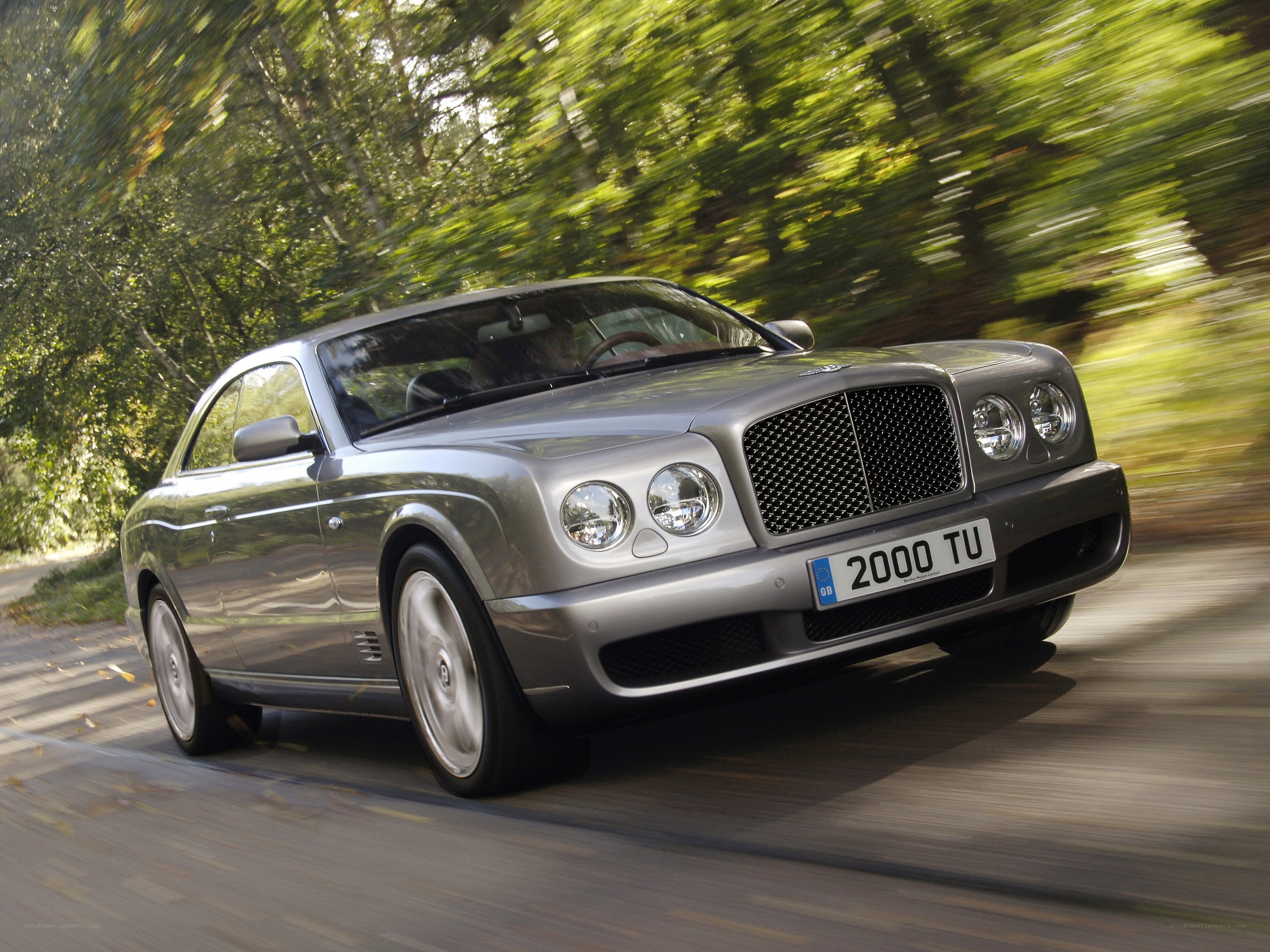 silver bentley driving on road