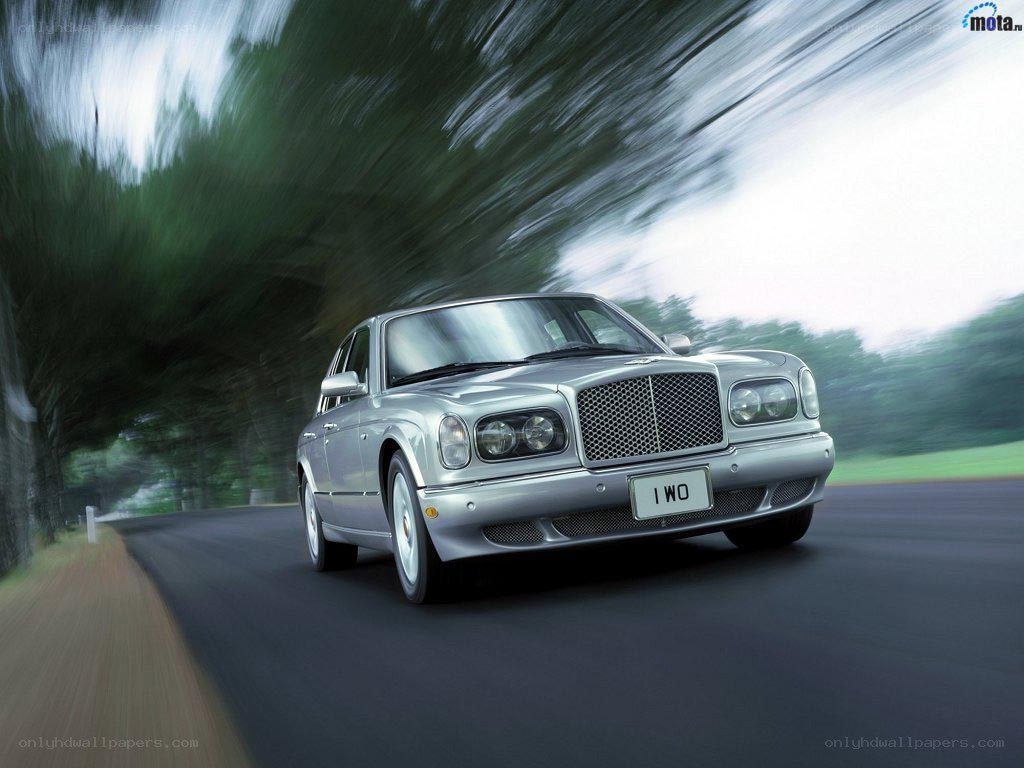 silver bentley driving on road