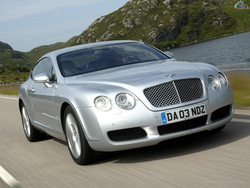 silver bentley driving on road