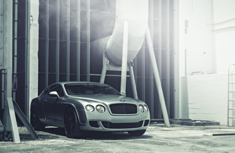 Silver Bentley in industrial setting