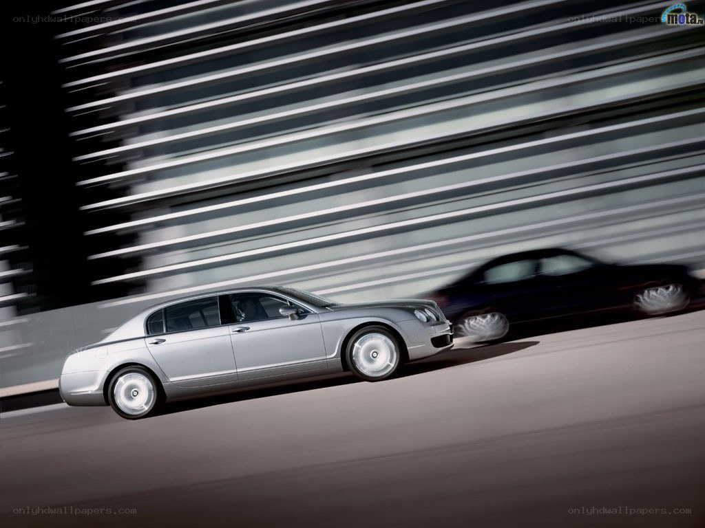 silver bentley in motion