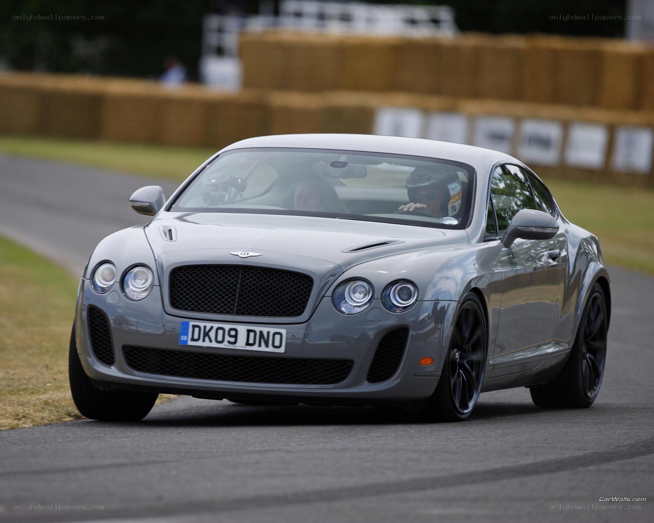 Silver Bentley on a racetrack
