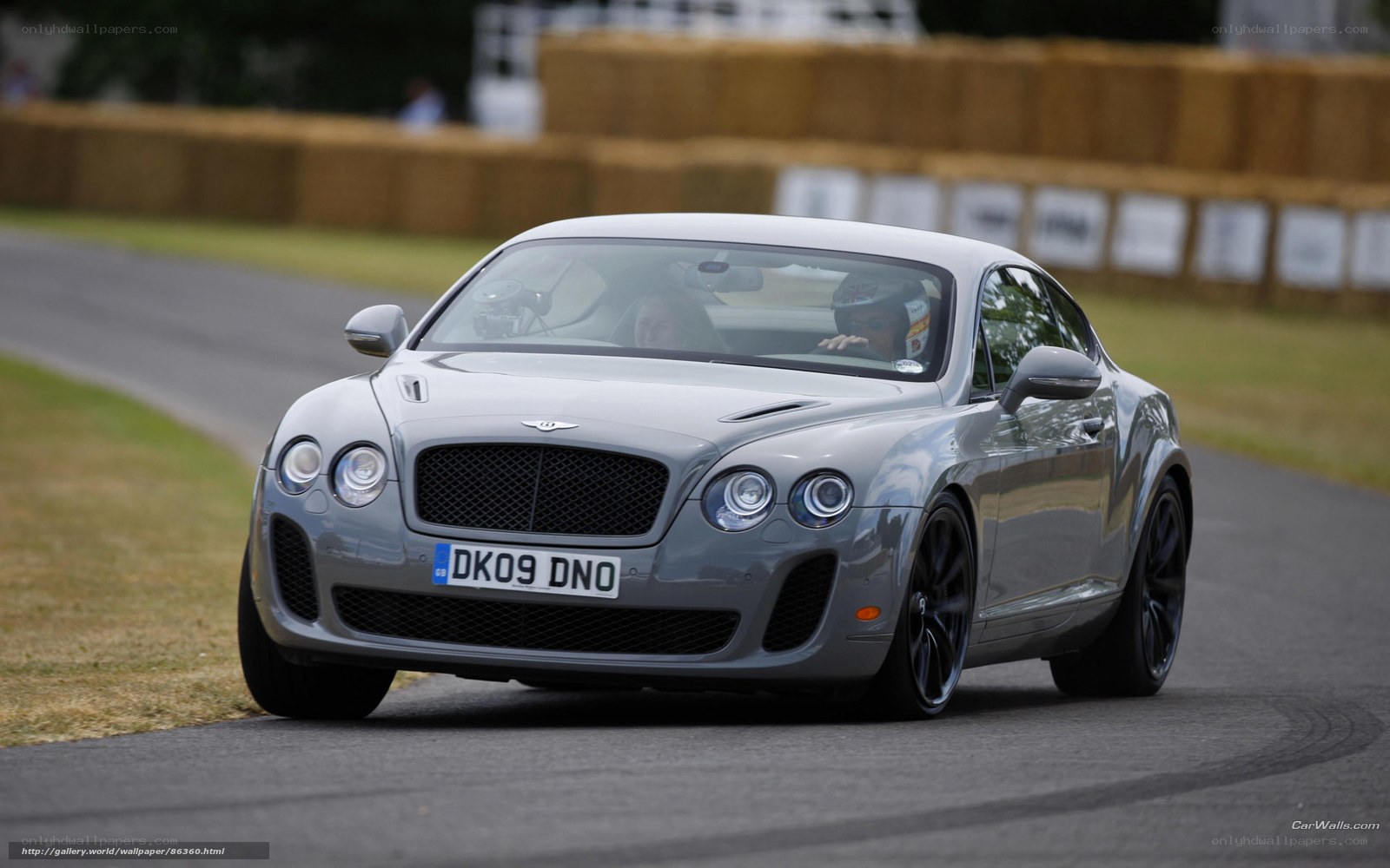 Silver Bentley on a racetrack