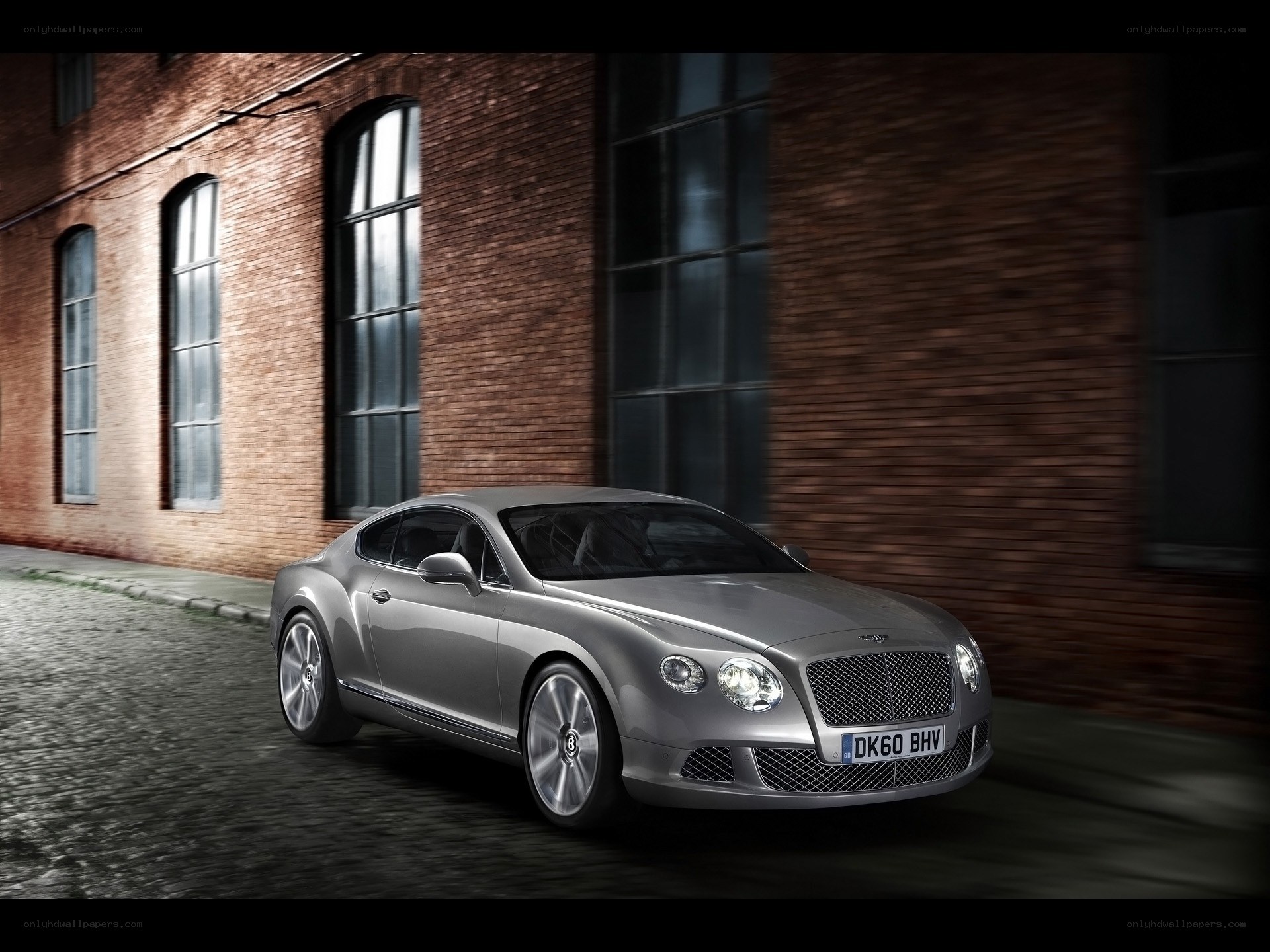 Silver Bentley on cobblestone street