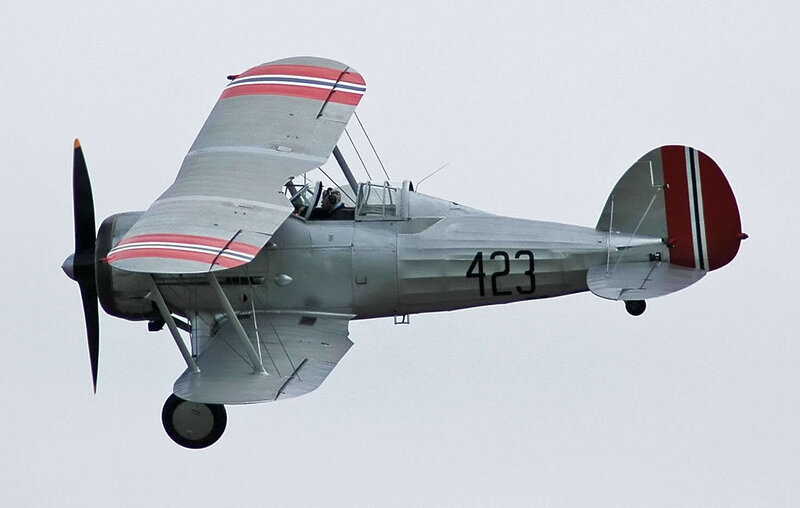 Silver Biplane in Flight