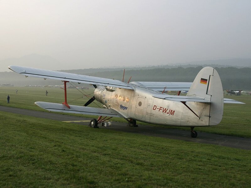 Silver biplane on airfield