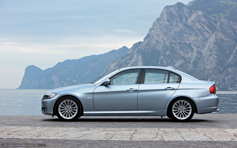Silver BMW 3 Series by the sea