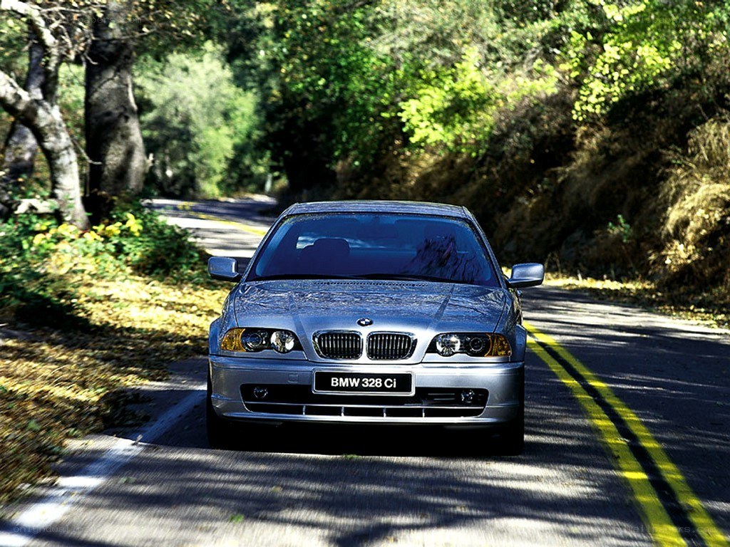 Silver BMW 328Ci on a forest road