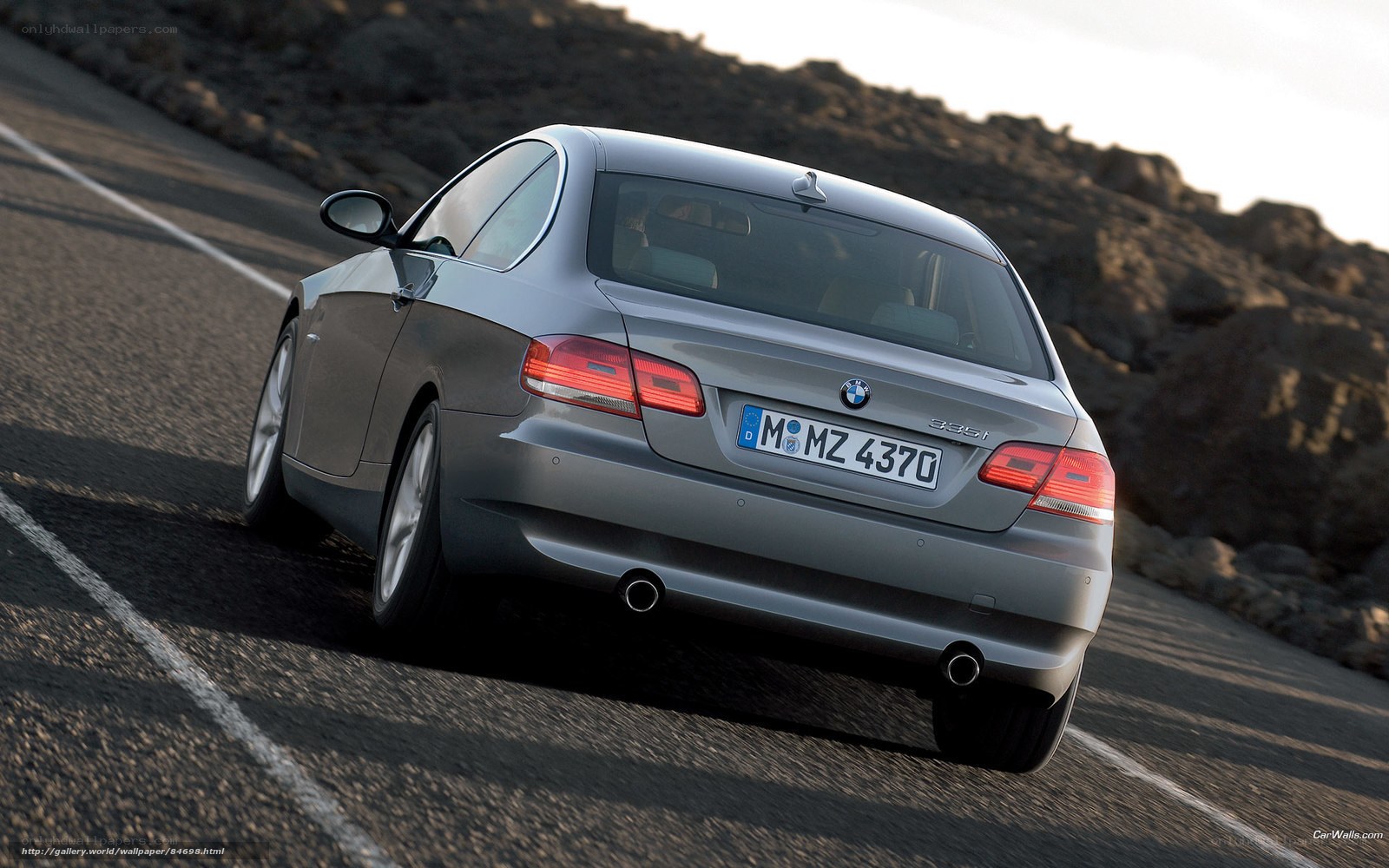 Silver BMW 335i on winding road