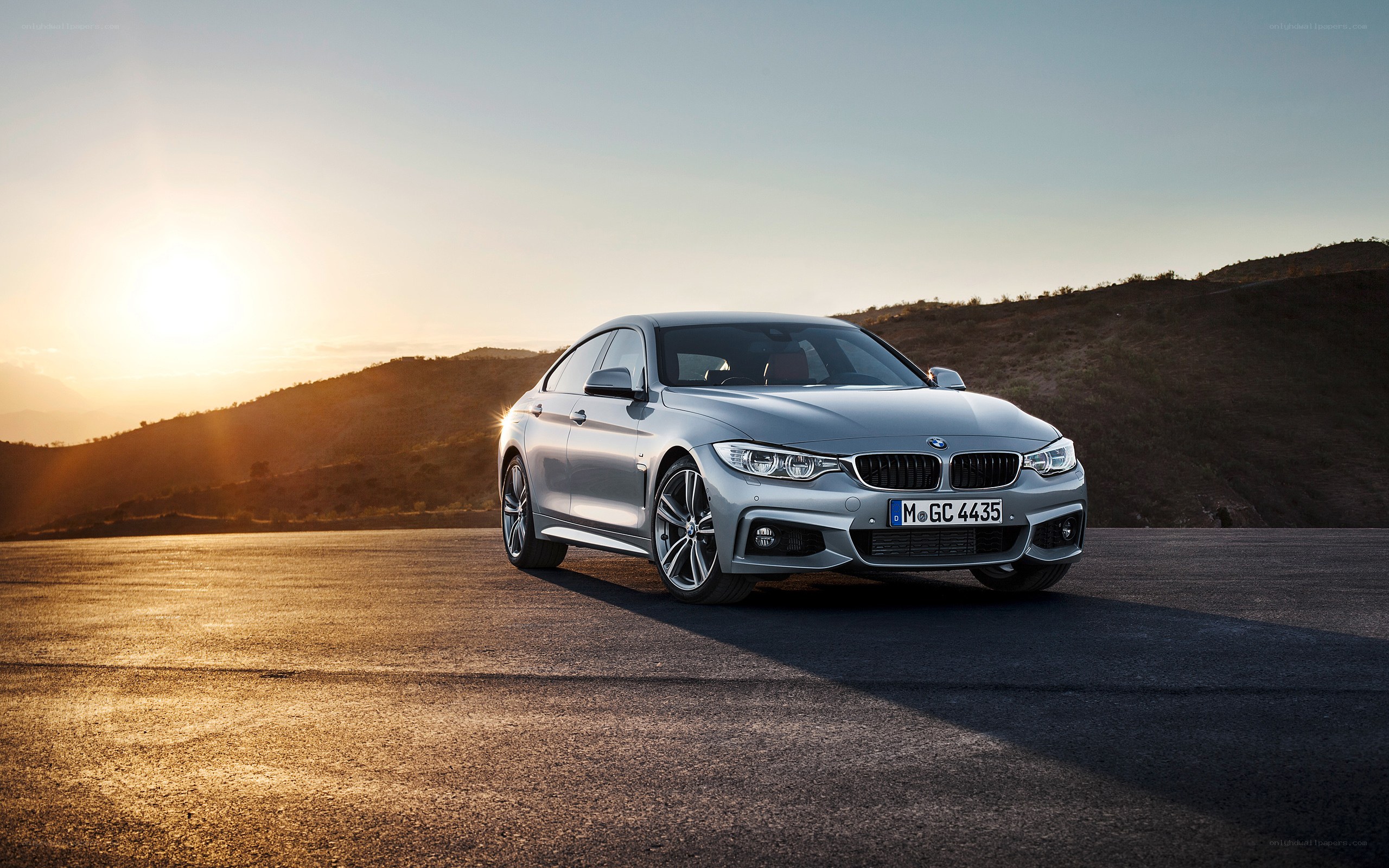 Silver BMW 4 Series at sunset