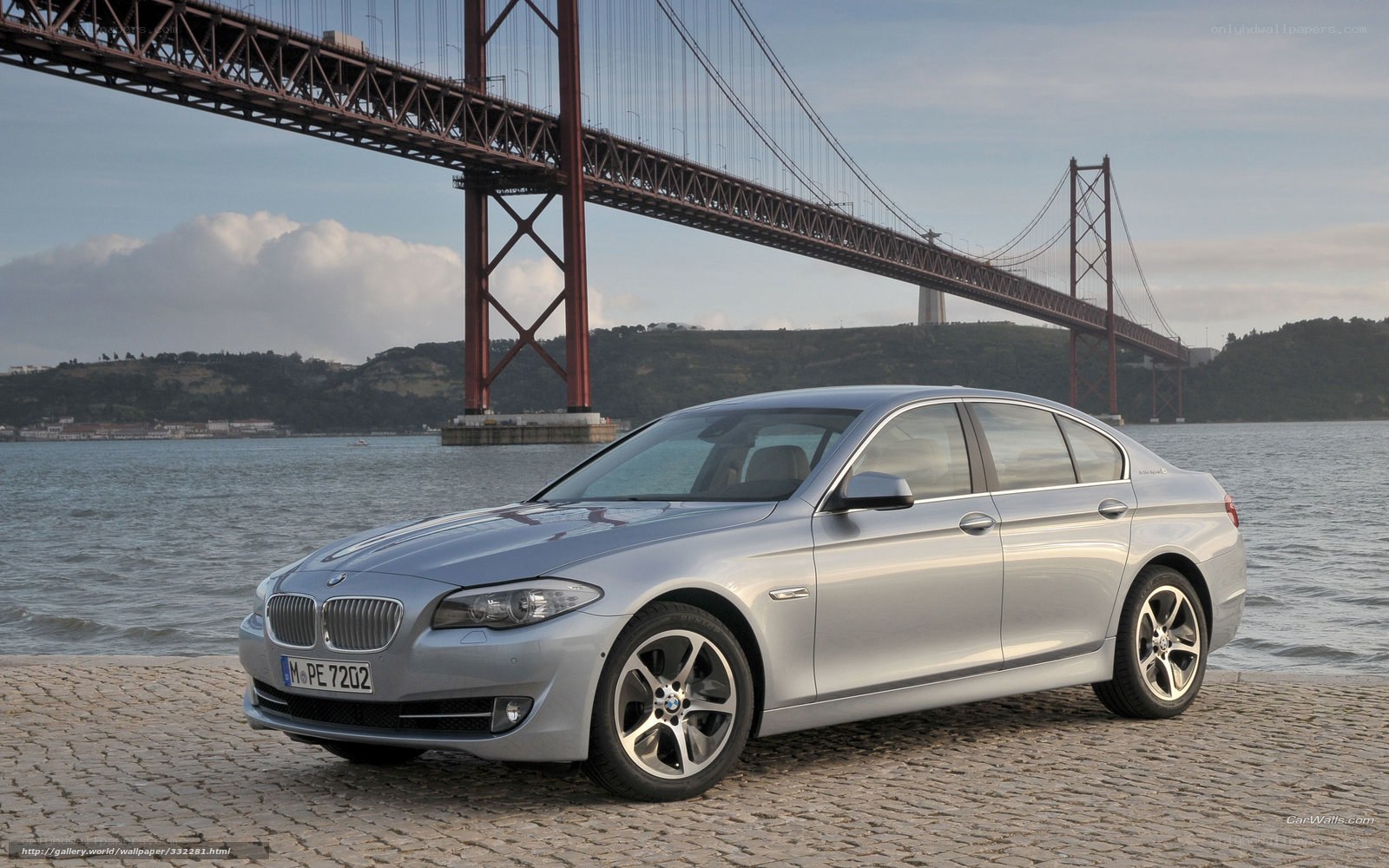 silver bmw 5 series by a bridge