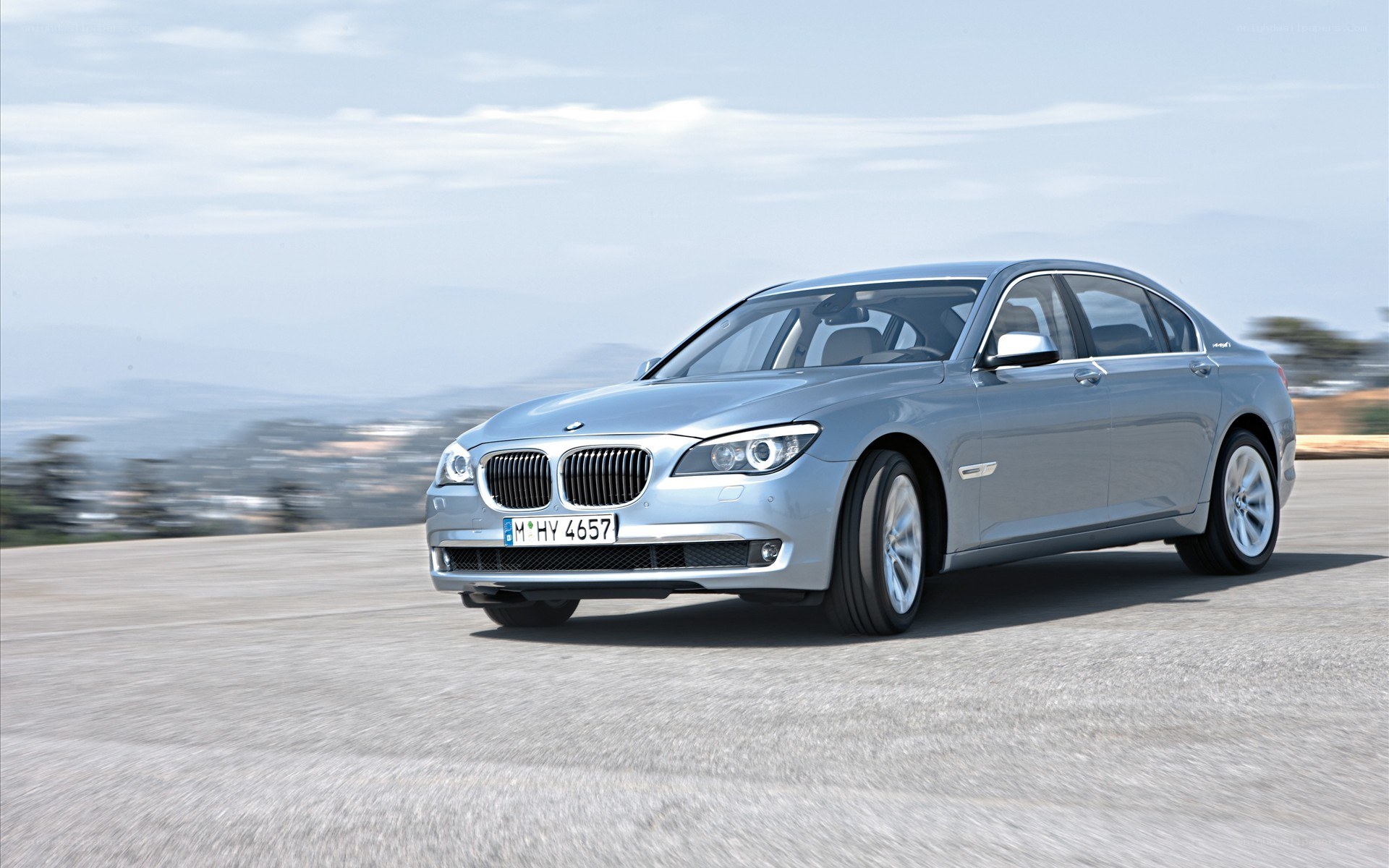 silver bmw 7-series driving