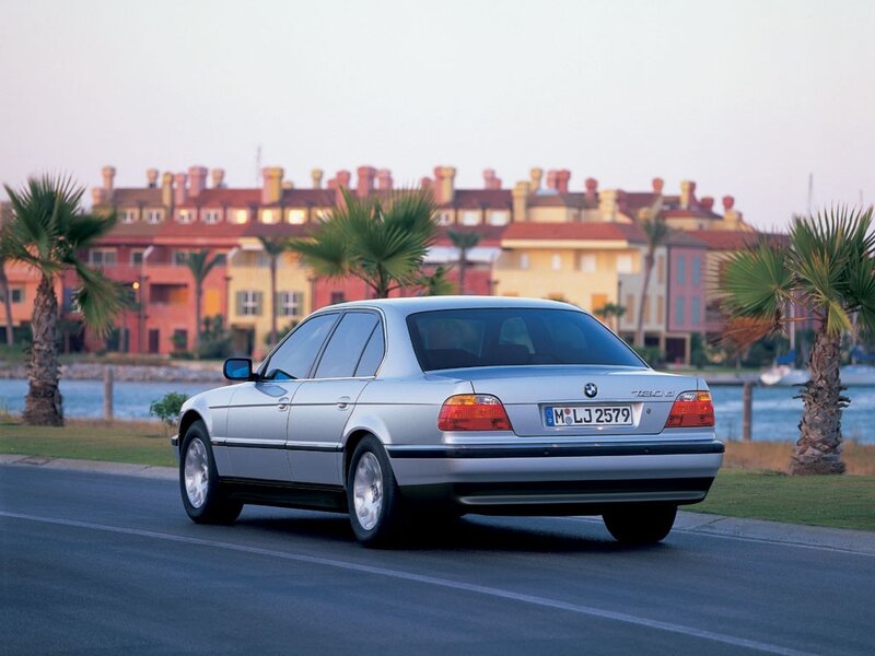 silver bmw 7-series on coastal road