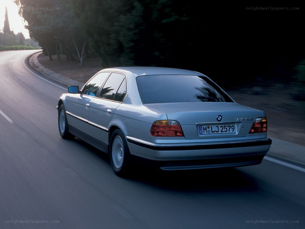 silver bmw 730d on a road