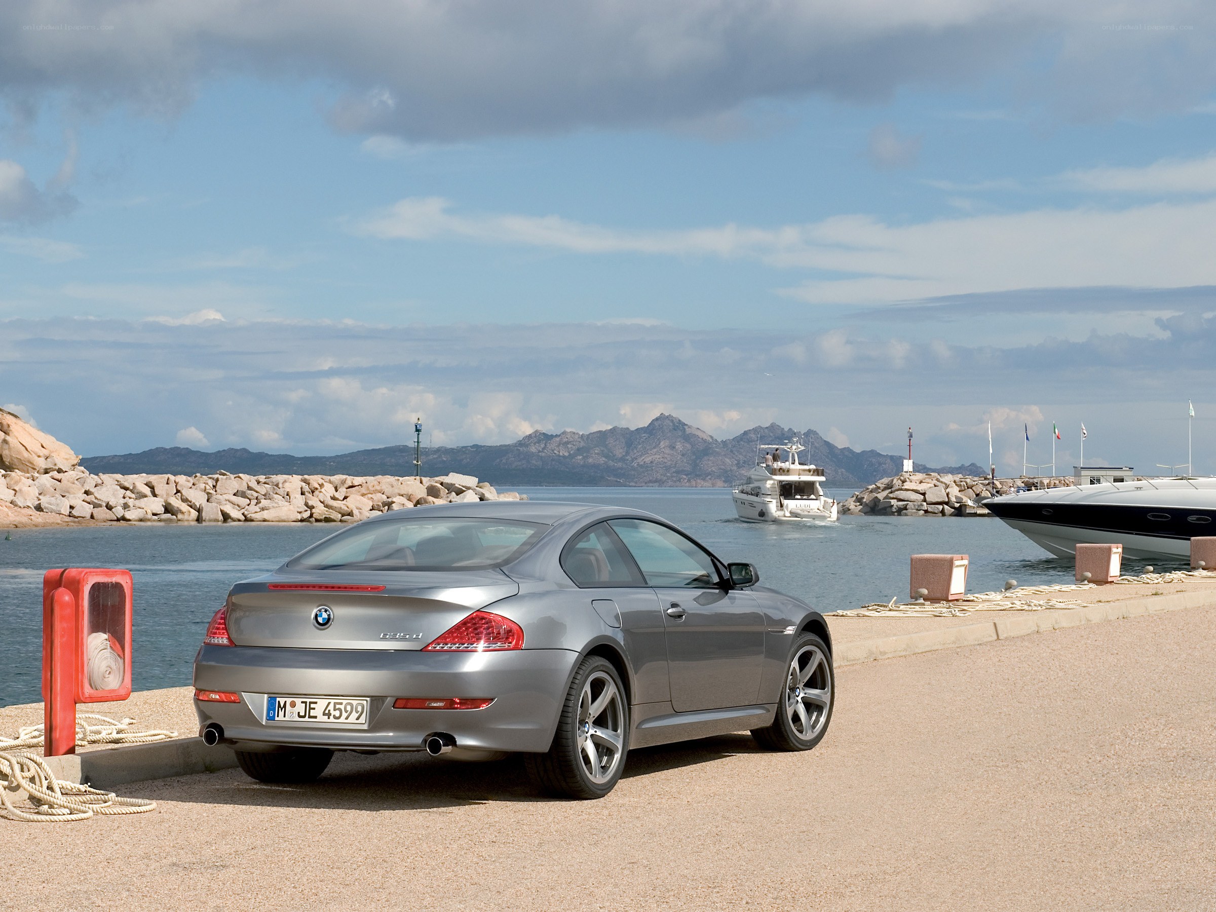 Silver BMW at a coastal marina