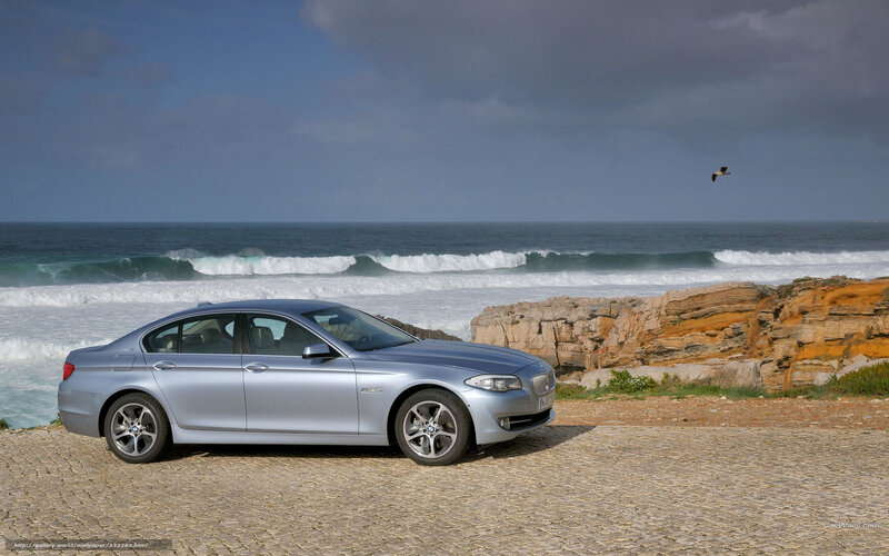 Silver BMW by the ocean