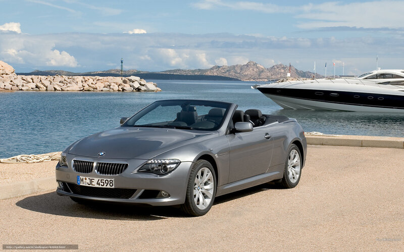 Silver BMW convertible by the harbor
