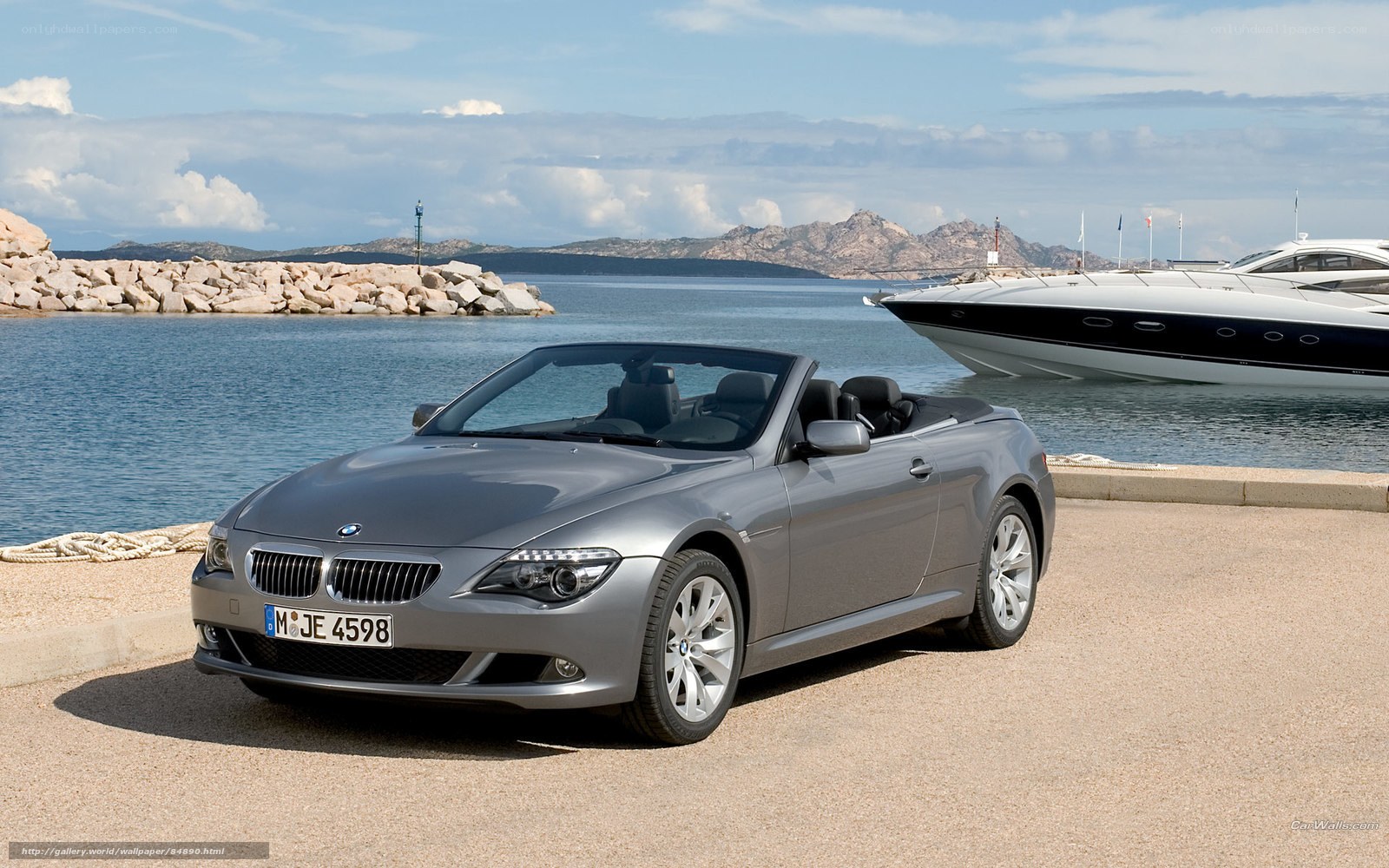 Silver BMW convertible by the harbor
