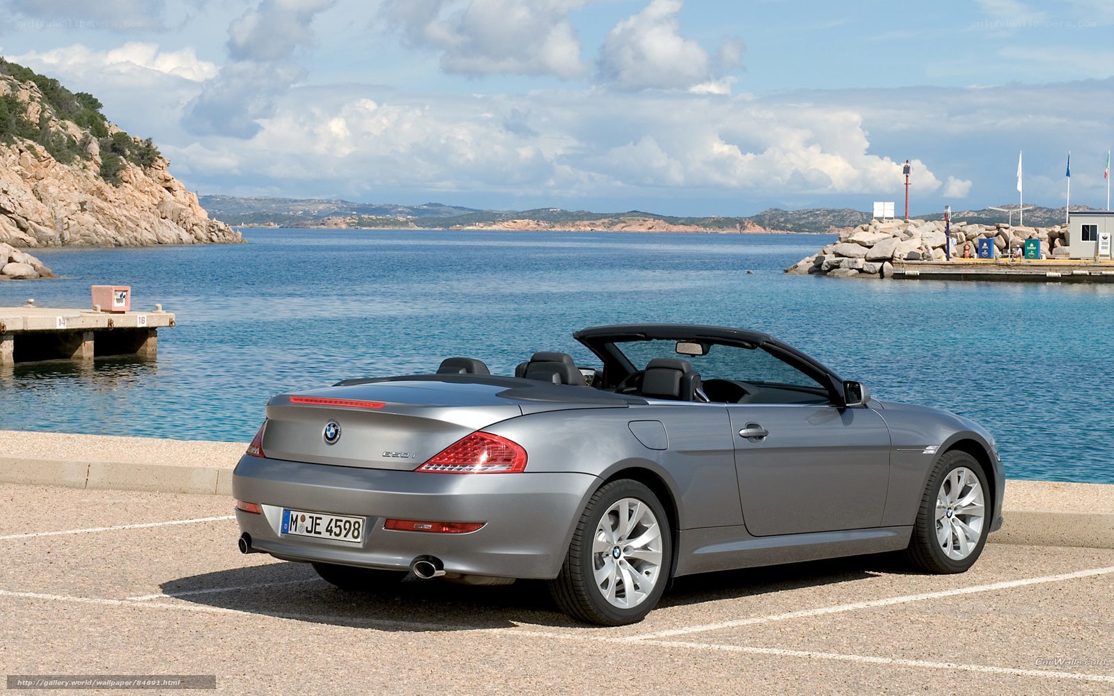 Silver BMW convertible by the sea