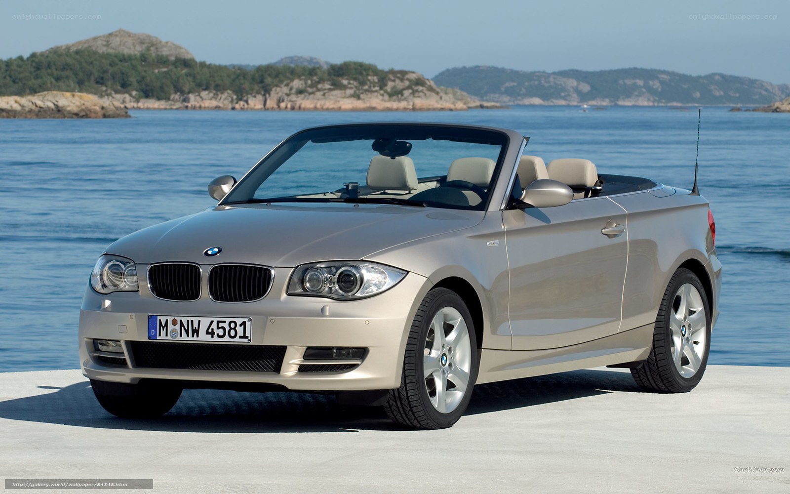 silver bmw convertible by the sea