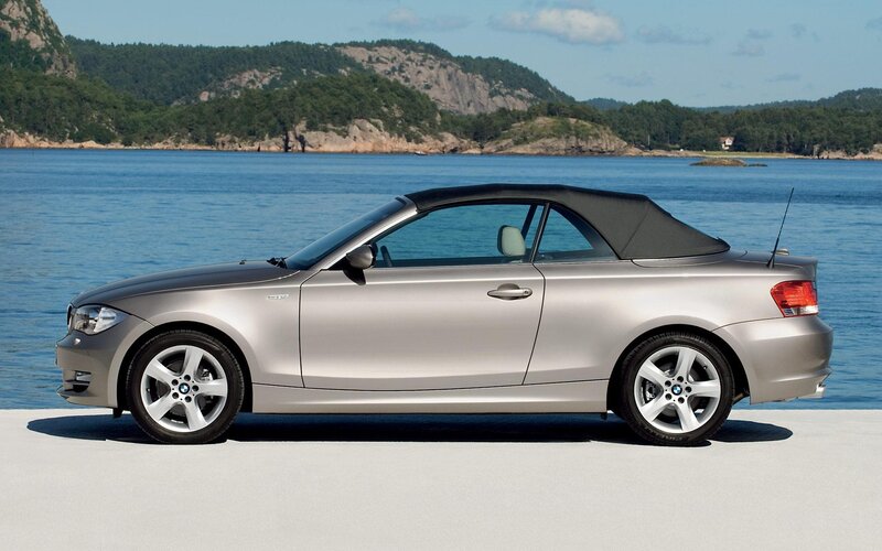 silver bmw convertible by the water