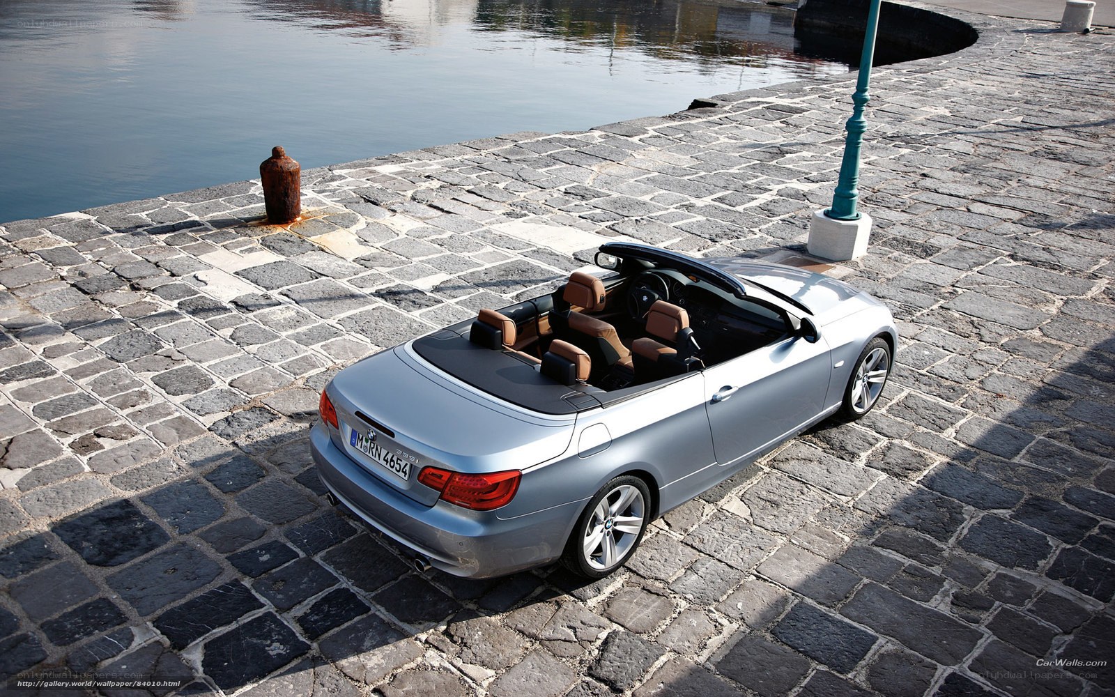 Silver BMW convertible by the water