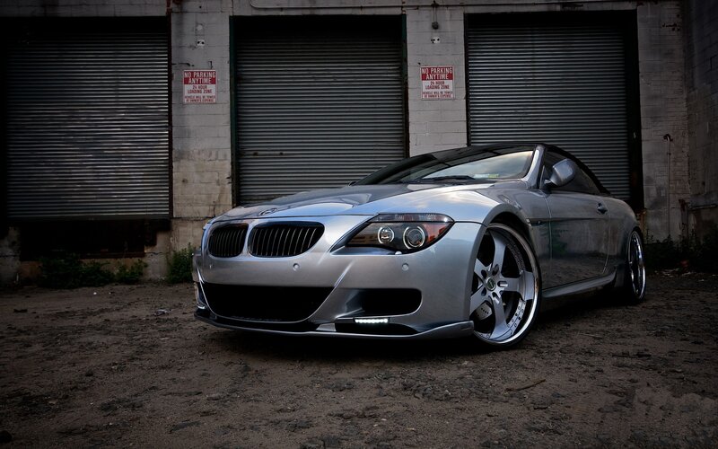 silver bmw convertible in alley