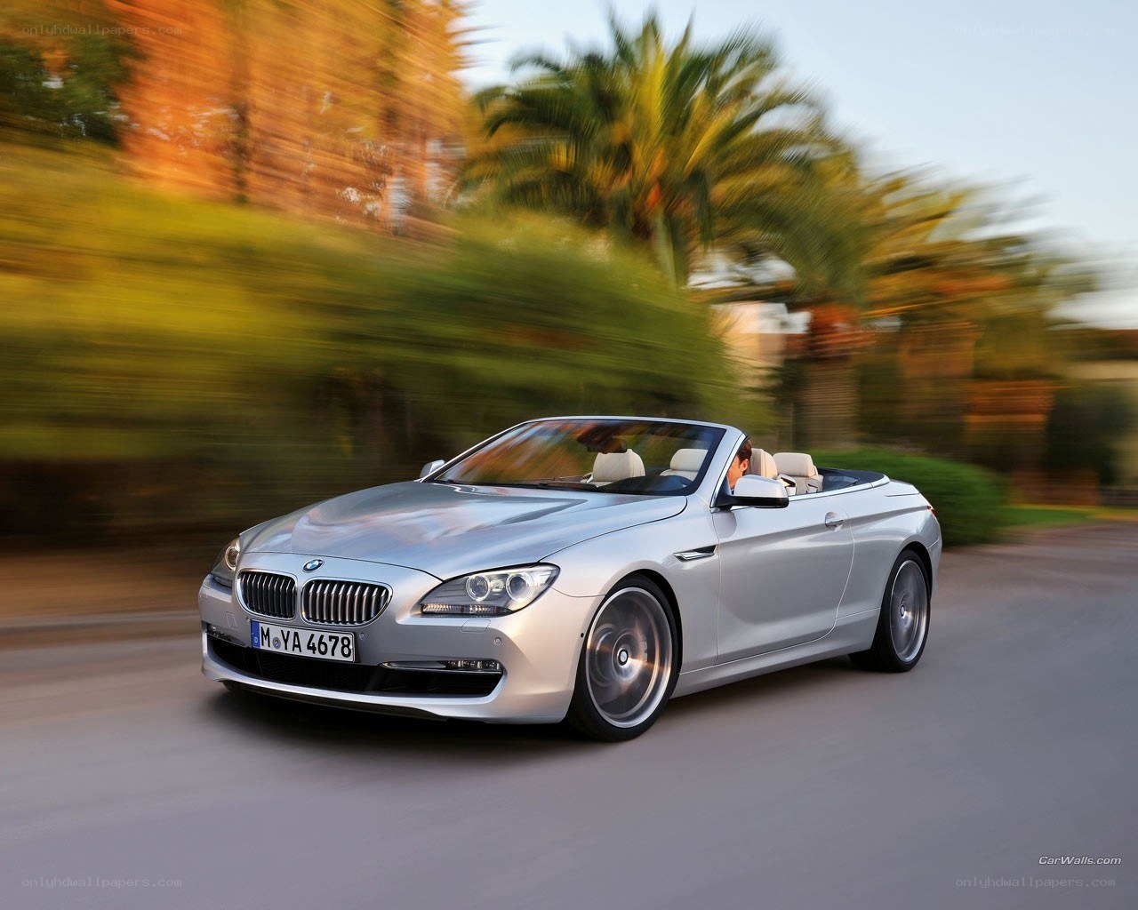 silver bmw convertible in motion