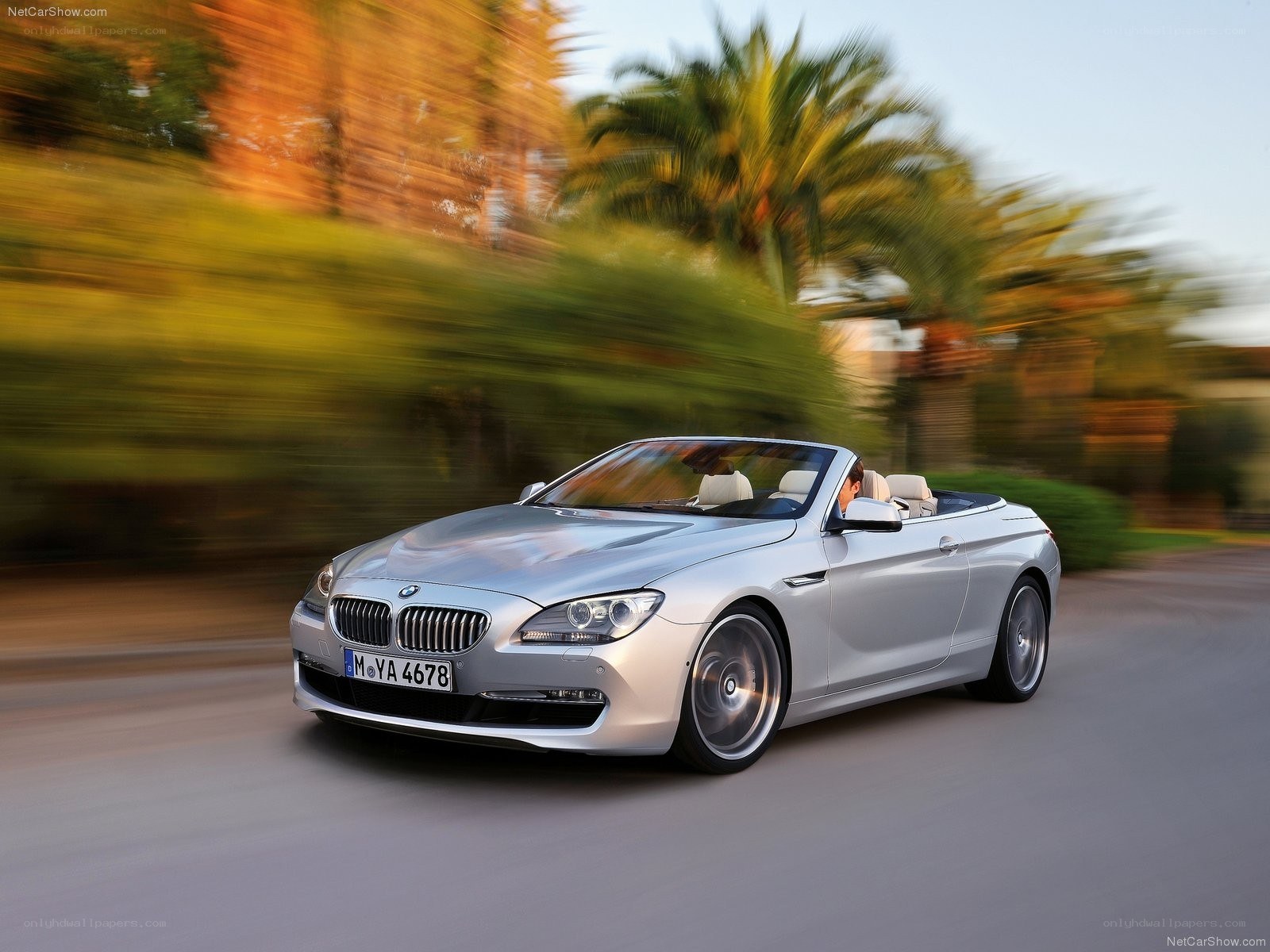 silver bmw convertible in motion