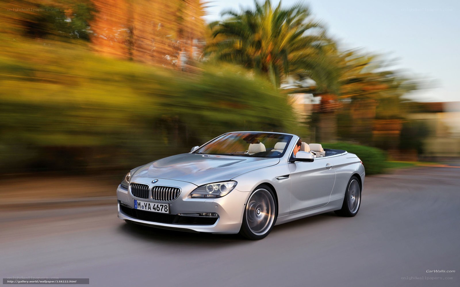 silver bmw convertible in motion