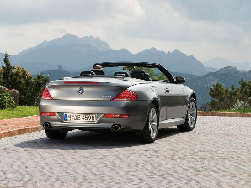 Silver BMW convertible on a scenic road