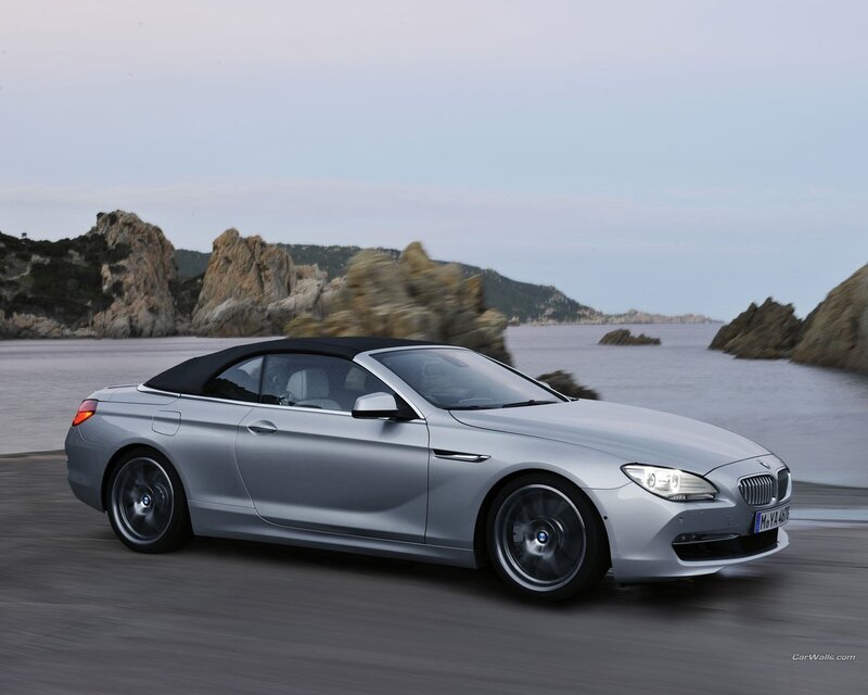 Silver BMW convertible on coastal road