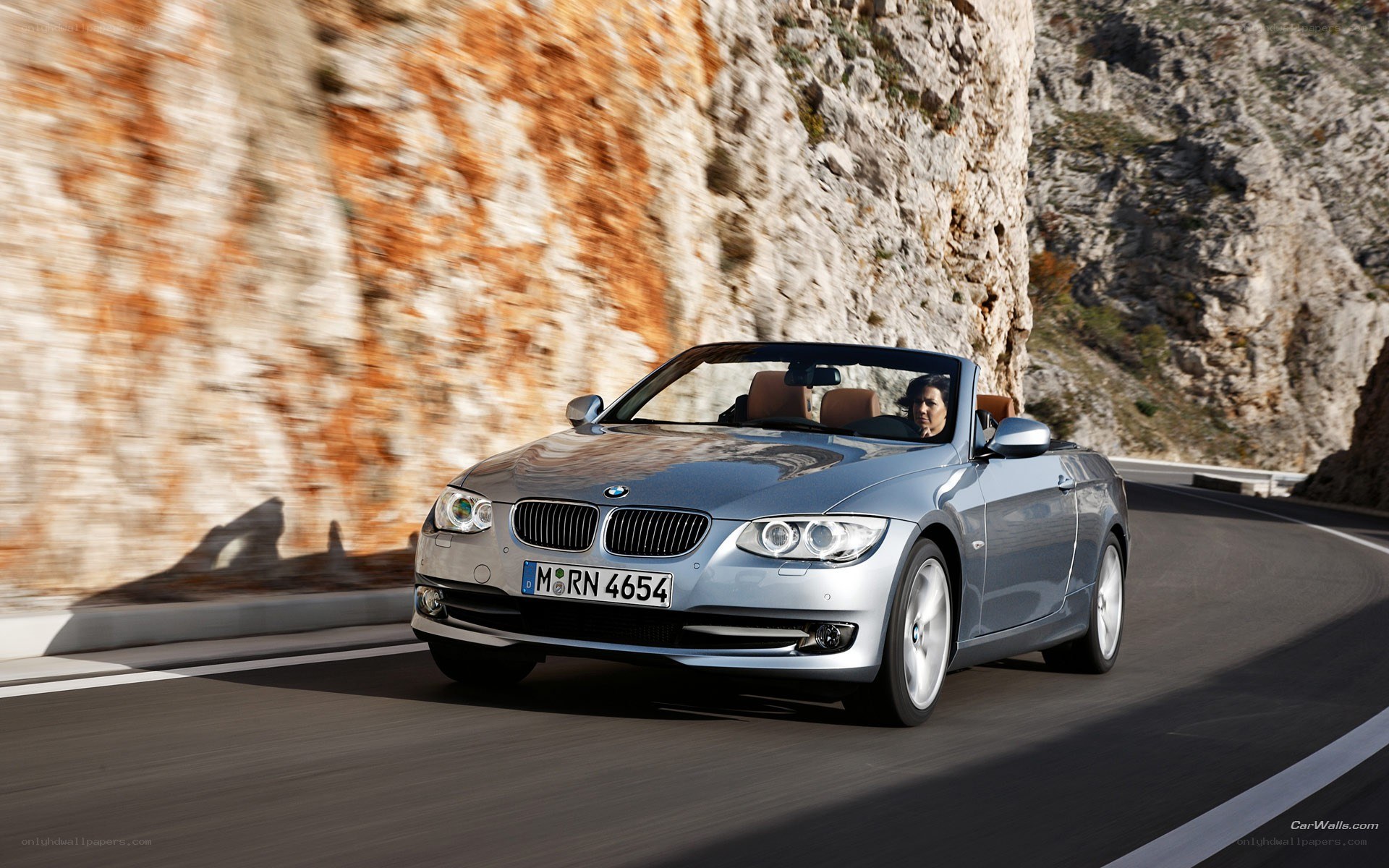 silver bmw convertible on mountain road