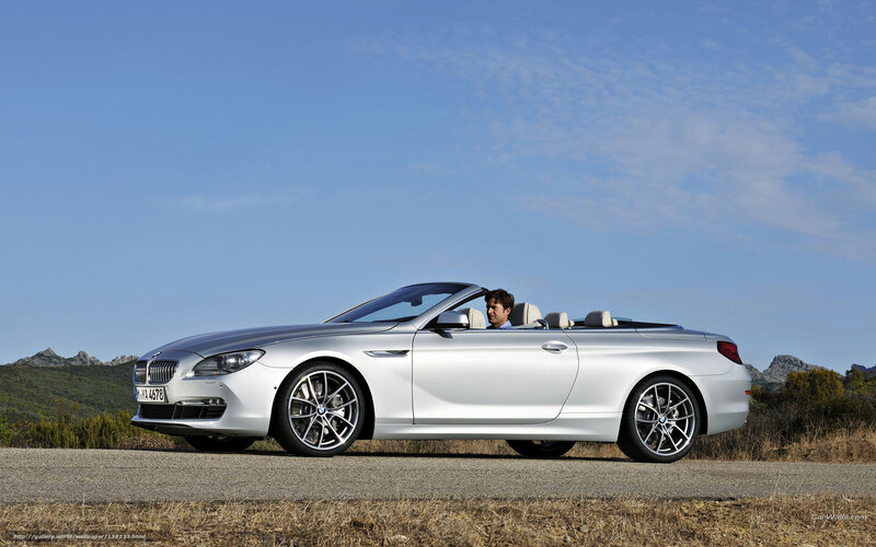 Silver BMW convertible on road
