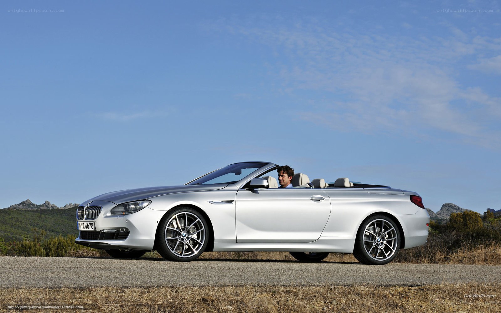 Silver BMW convertible on road
