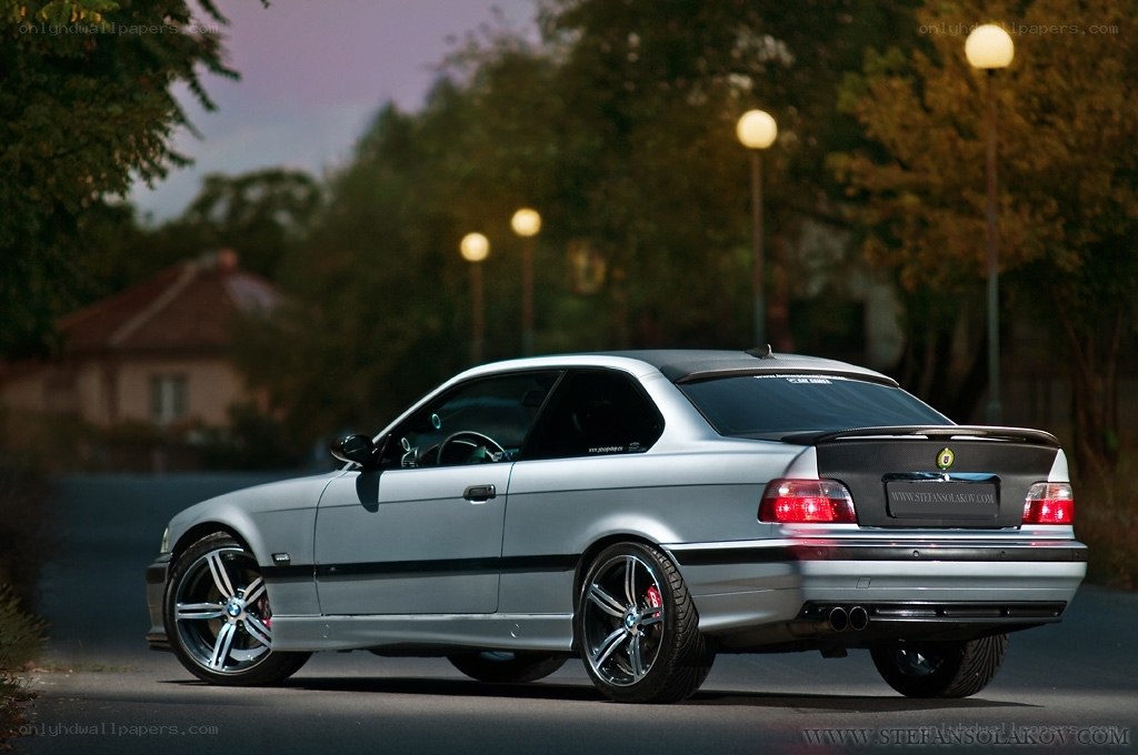 silver bmw coupe at dusk