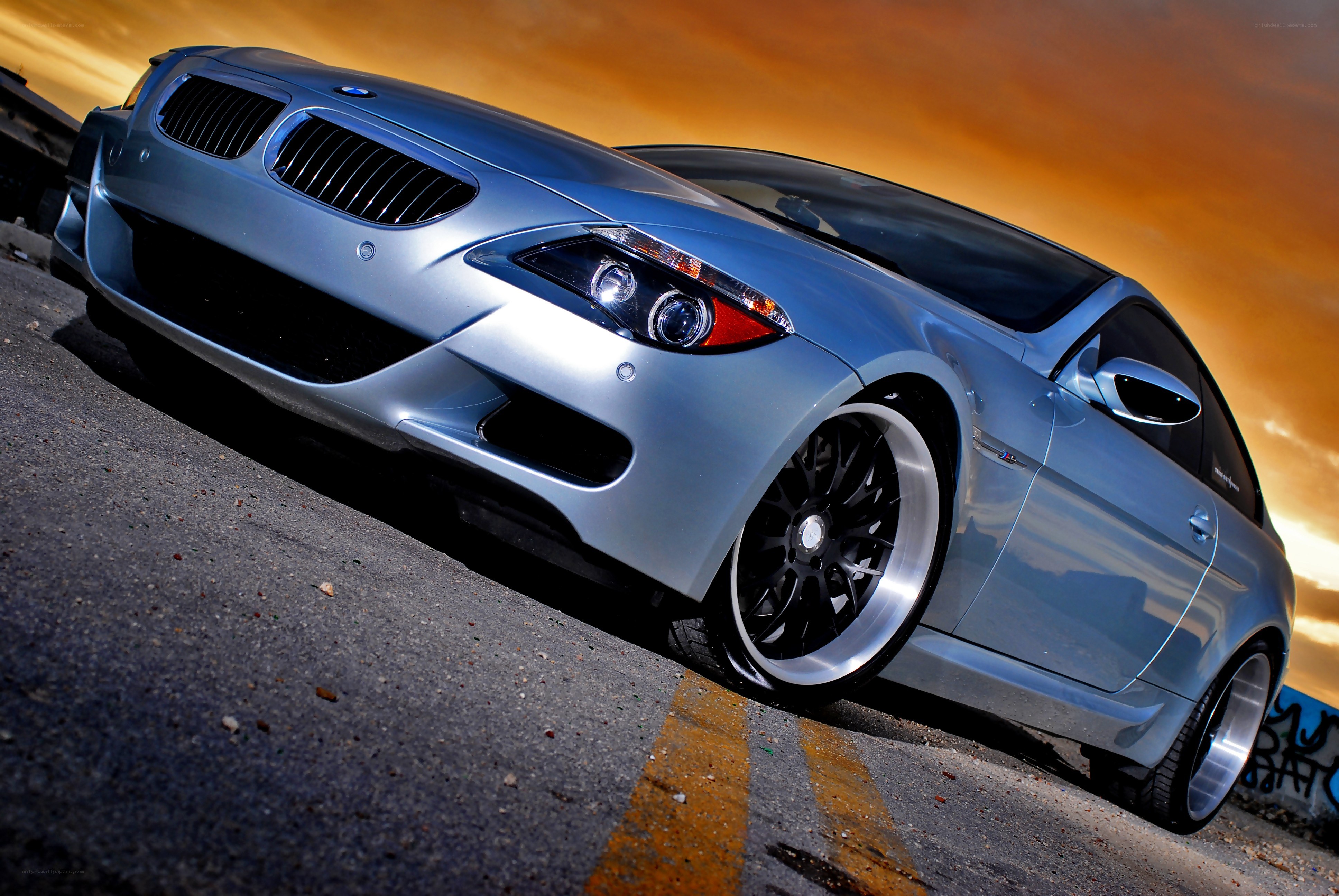 silver bmw coupe at sunset