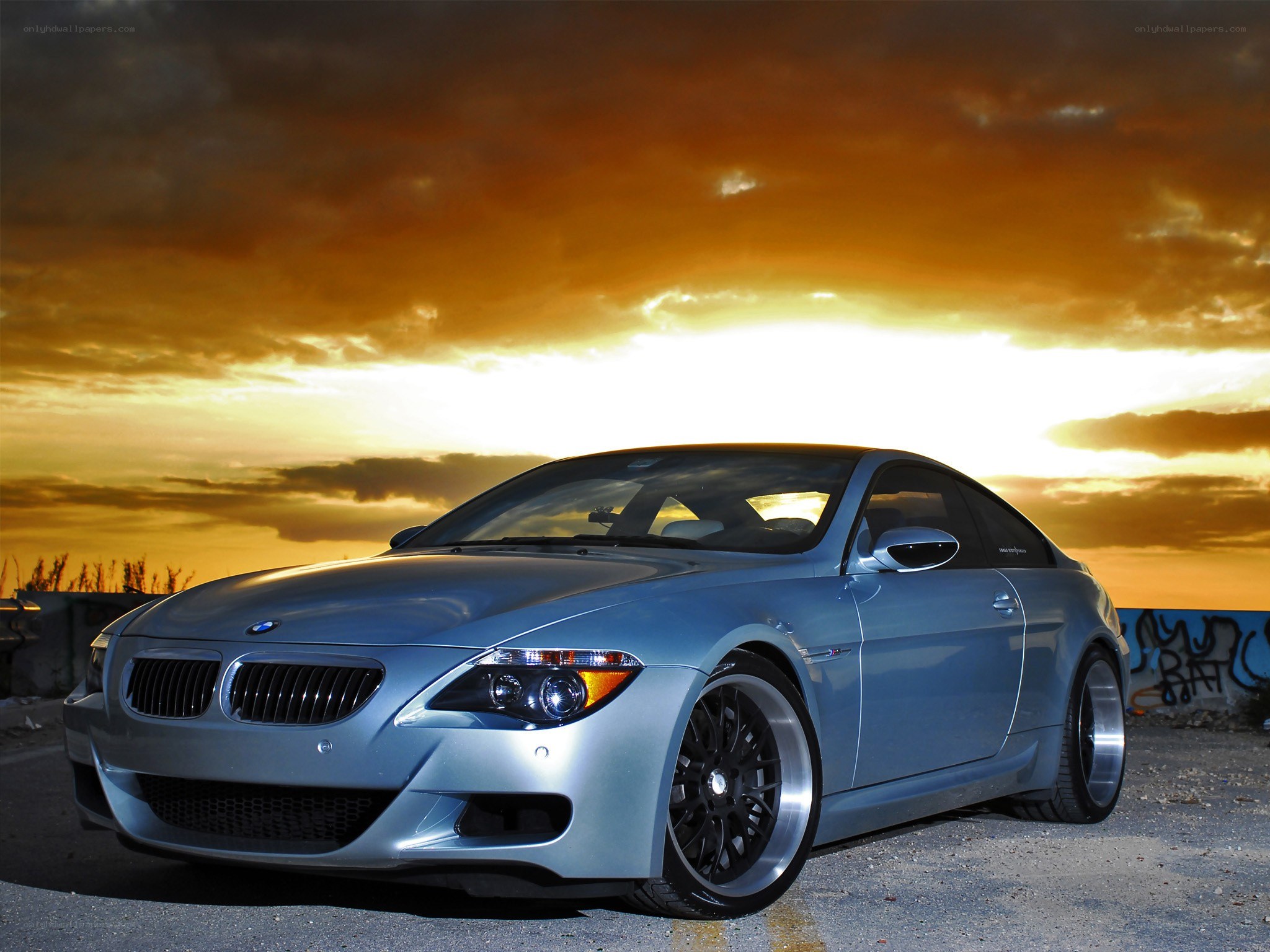 silver bmw coupe at sunset