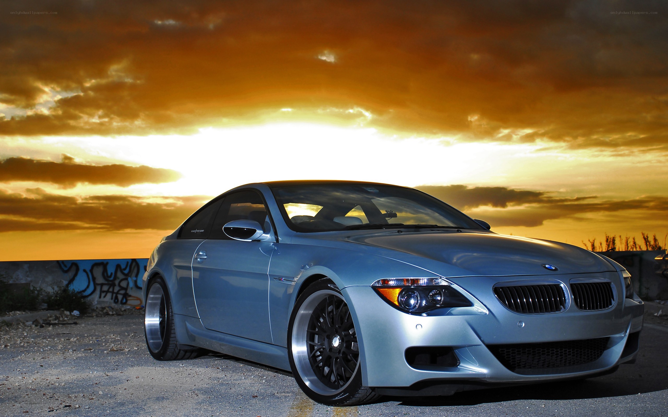 silver bmw coupe at sunset