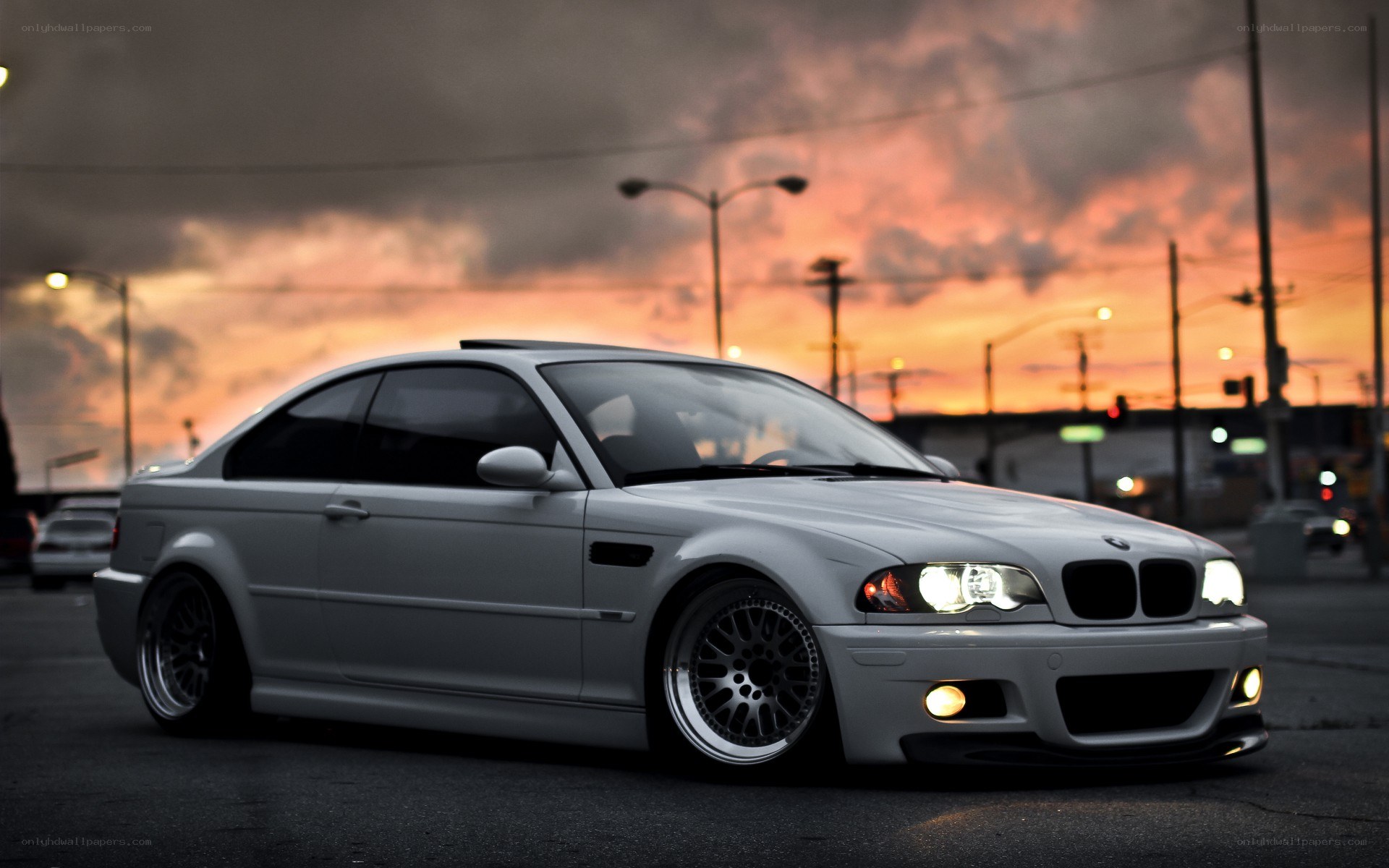 silver bmw coupe at sunset