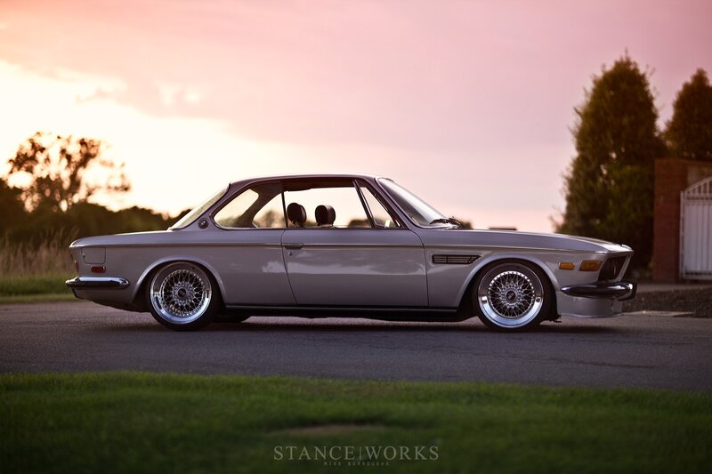 silver bmw coupe at sunset
