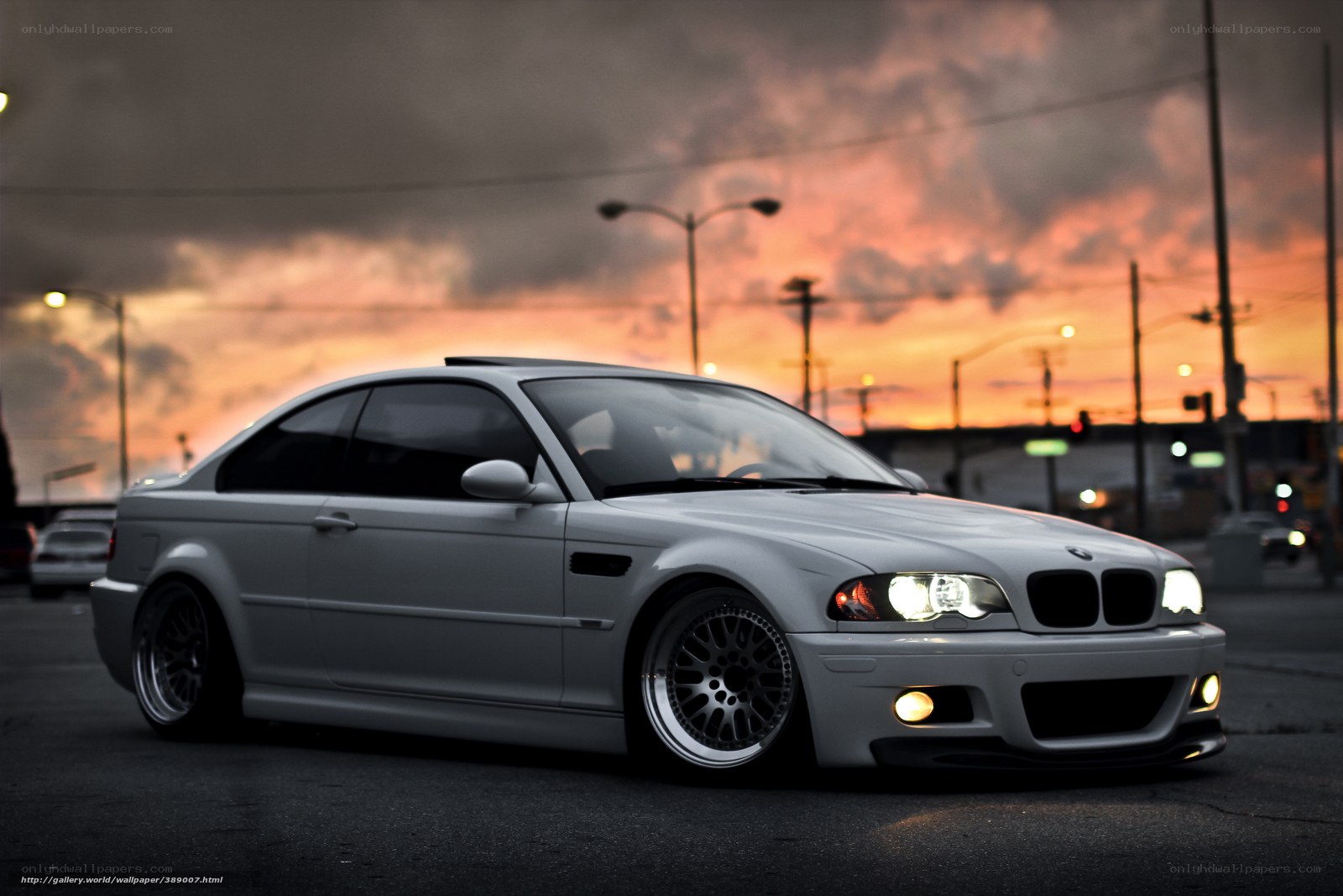 silver bmw coupe at sunset