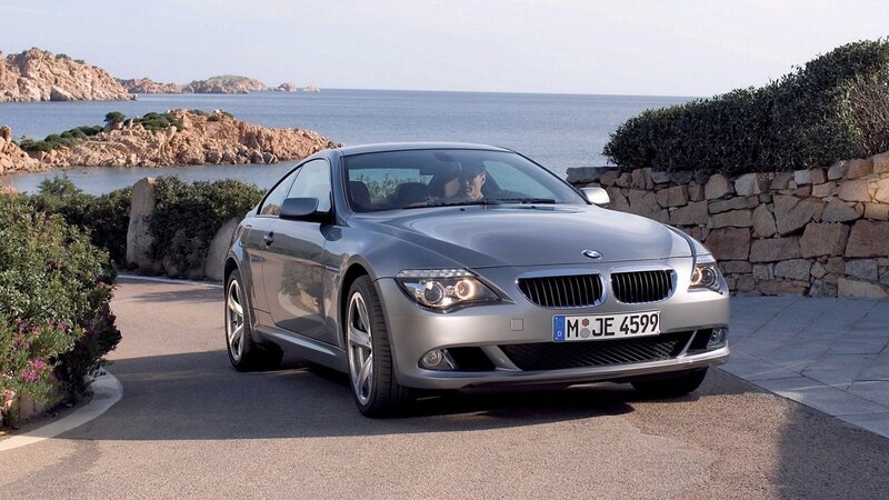 Silver BMW coupe by the sea