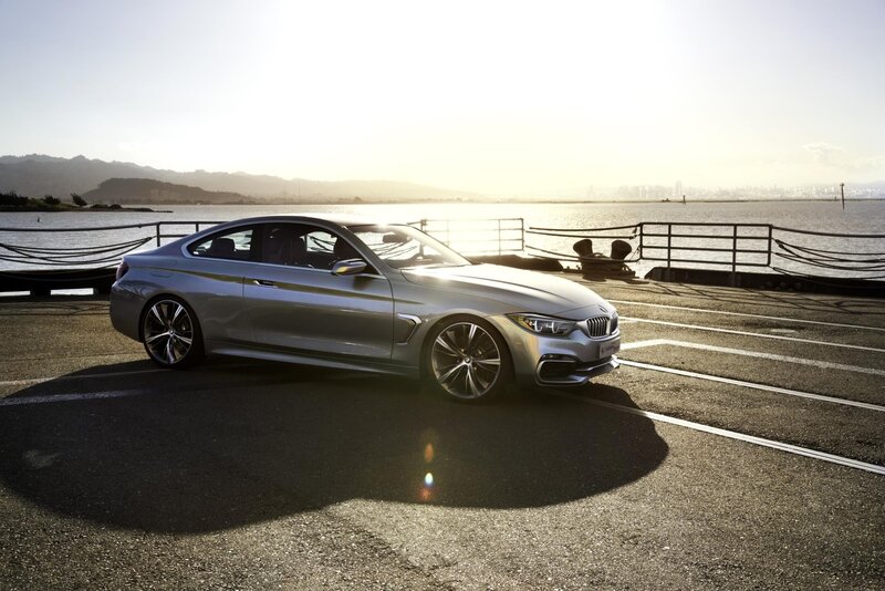 Silver BMW coupe by the water