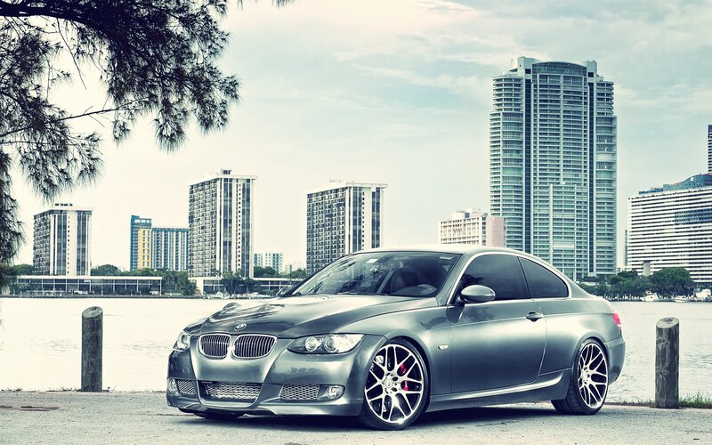 silver bmw coupe by the water
